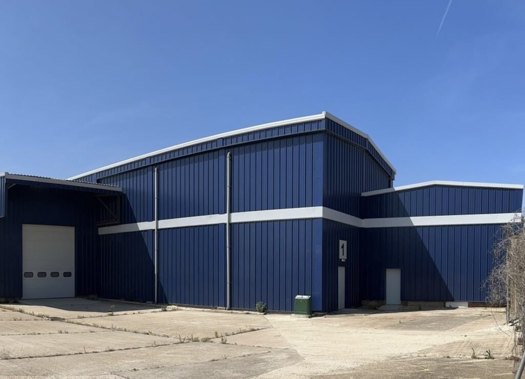 Exterior of warehouse with cladding spraying