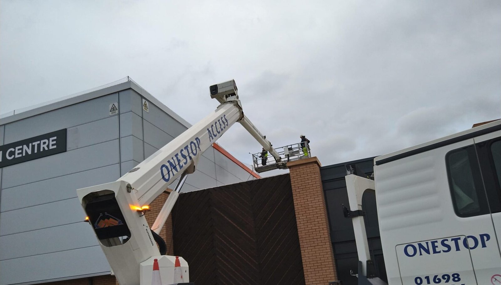 Commercial painting workers using a boom lift to access high areas